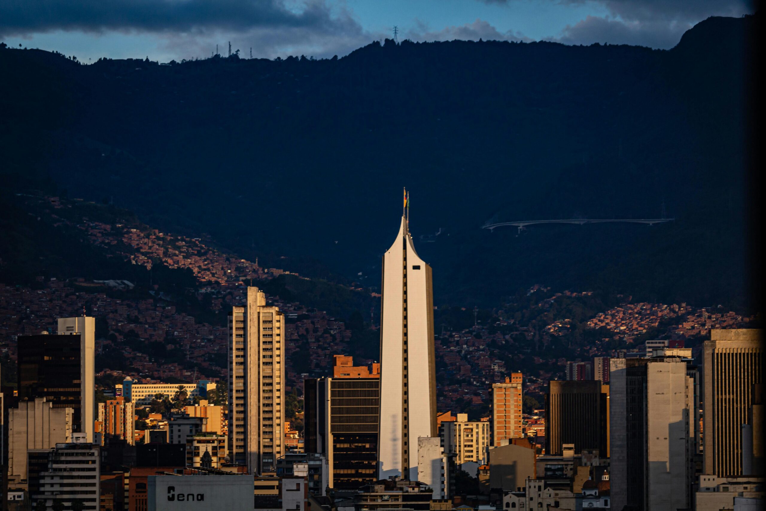 Dramatic sunset view of Medellín's skyline with the iconic Coltejer building.